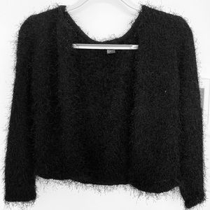 A black, fuzzy, H&M sweater